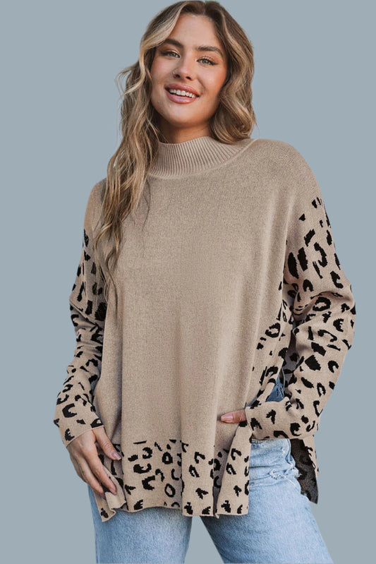 A woman wearing a beige and brown leopard print pullover sweater with a round neckline, long sleeves, and a split hem.