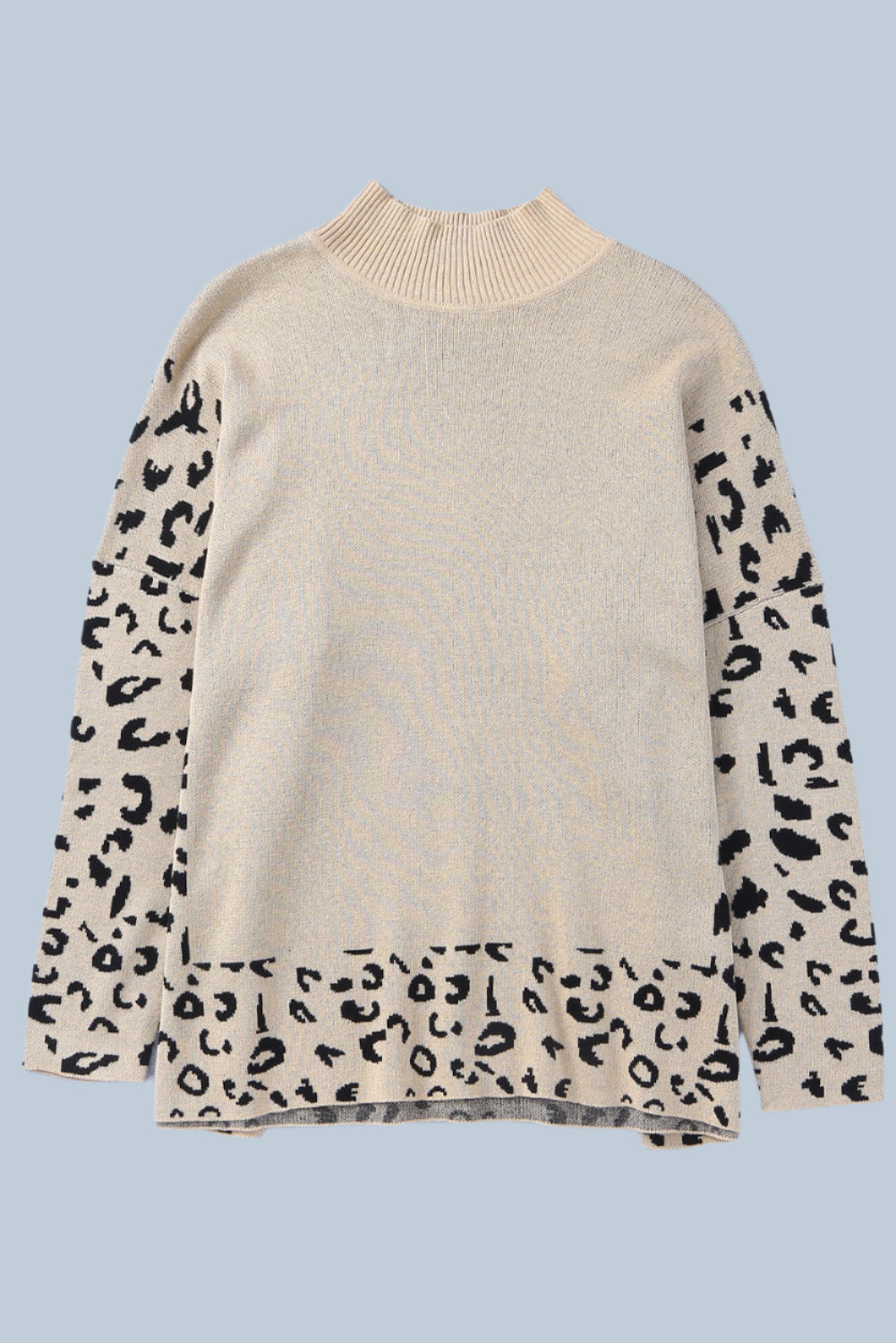 Beige sweater with leopard print sleeves on a light blue background
