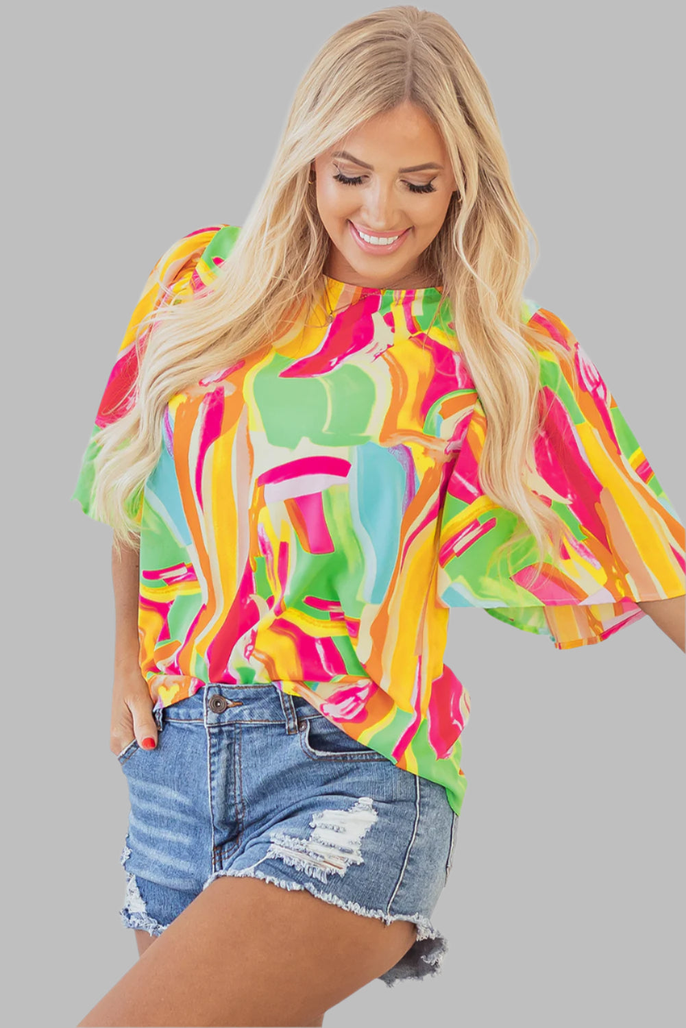 multicolour abstract print blouse, front side view, woman smiles