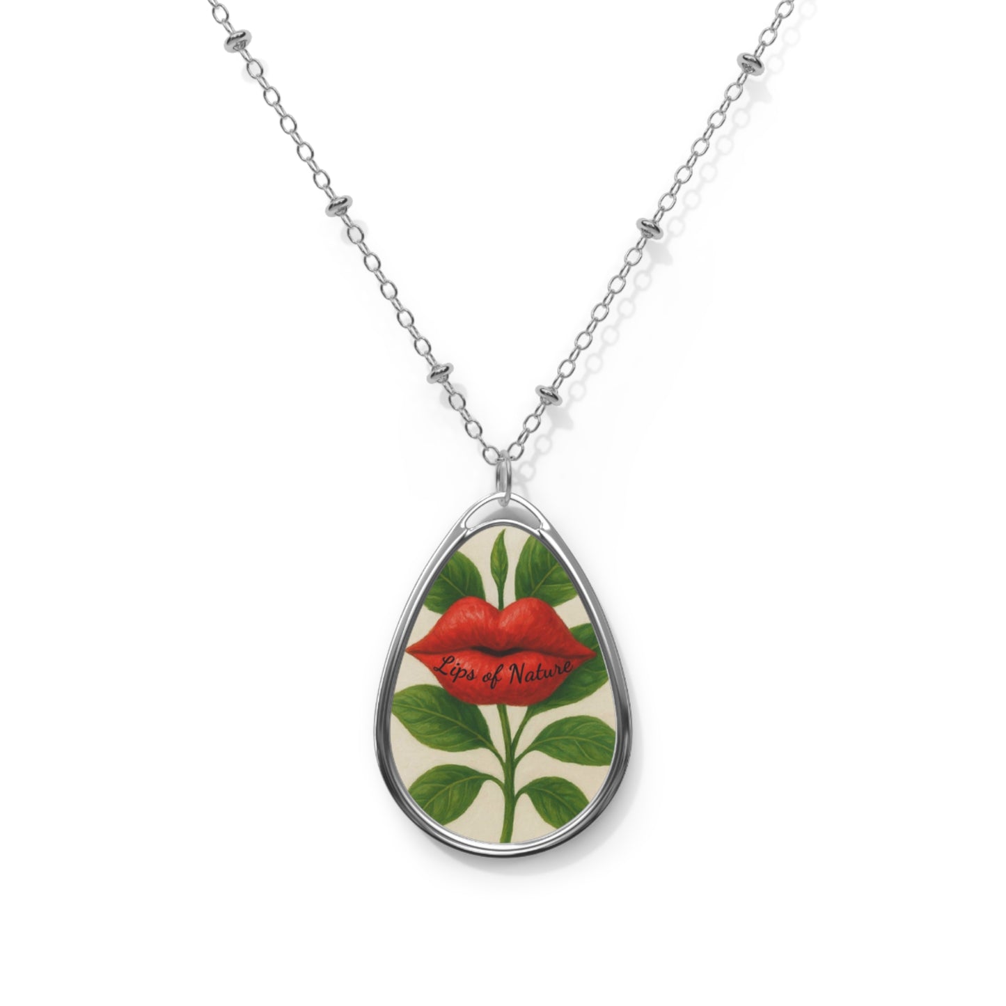 Teardrop-shaped pendant with floral design and red lips on a white background