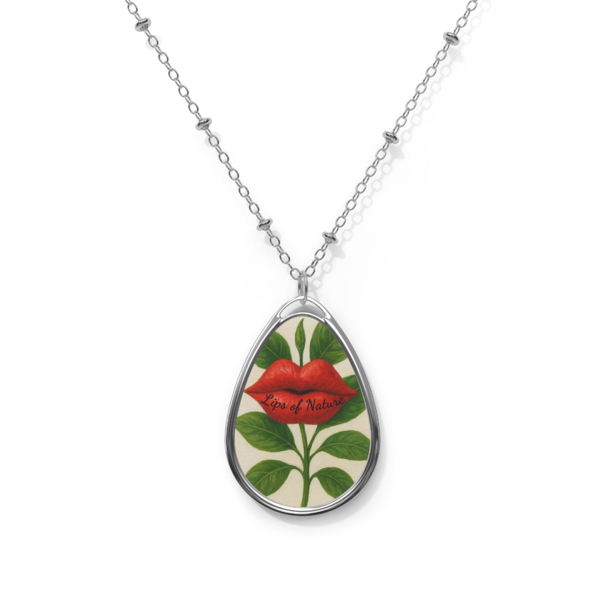 Teardrop-shaped pendant with floral design and red lips on a white background
