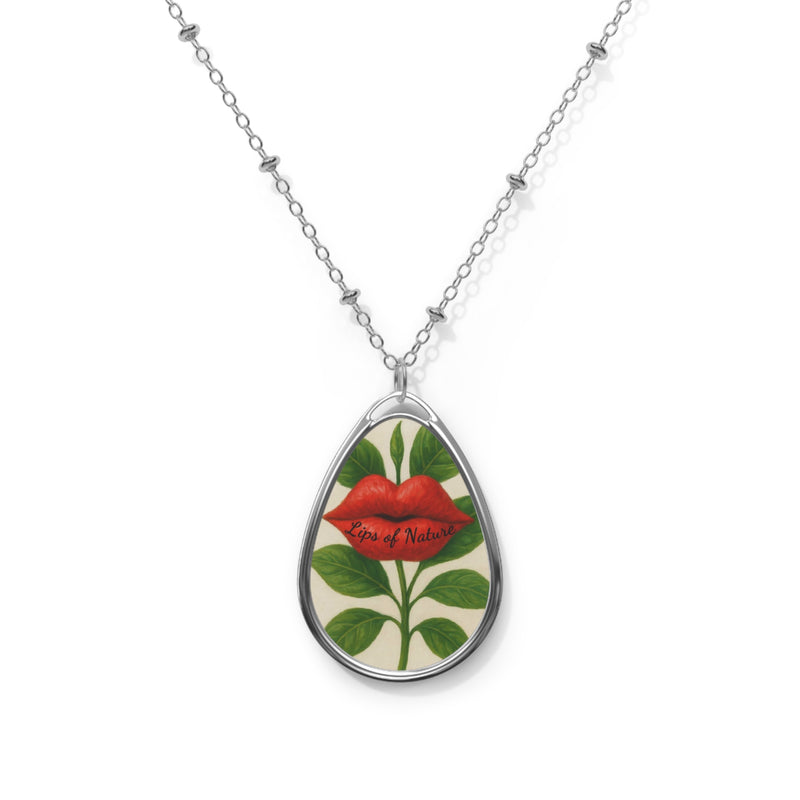 Teardrop-shaped pendant with floral design and red lips on a white background