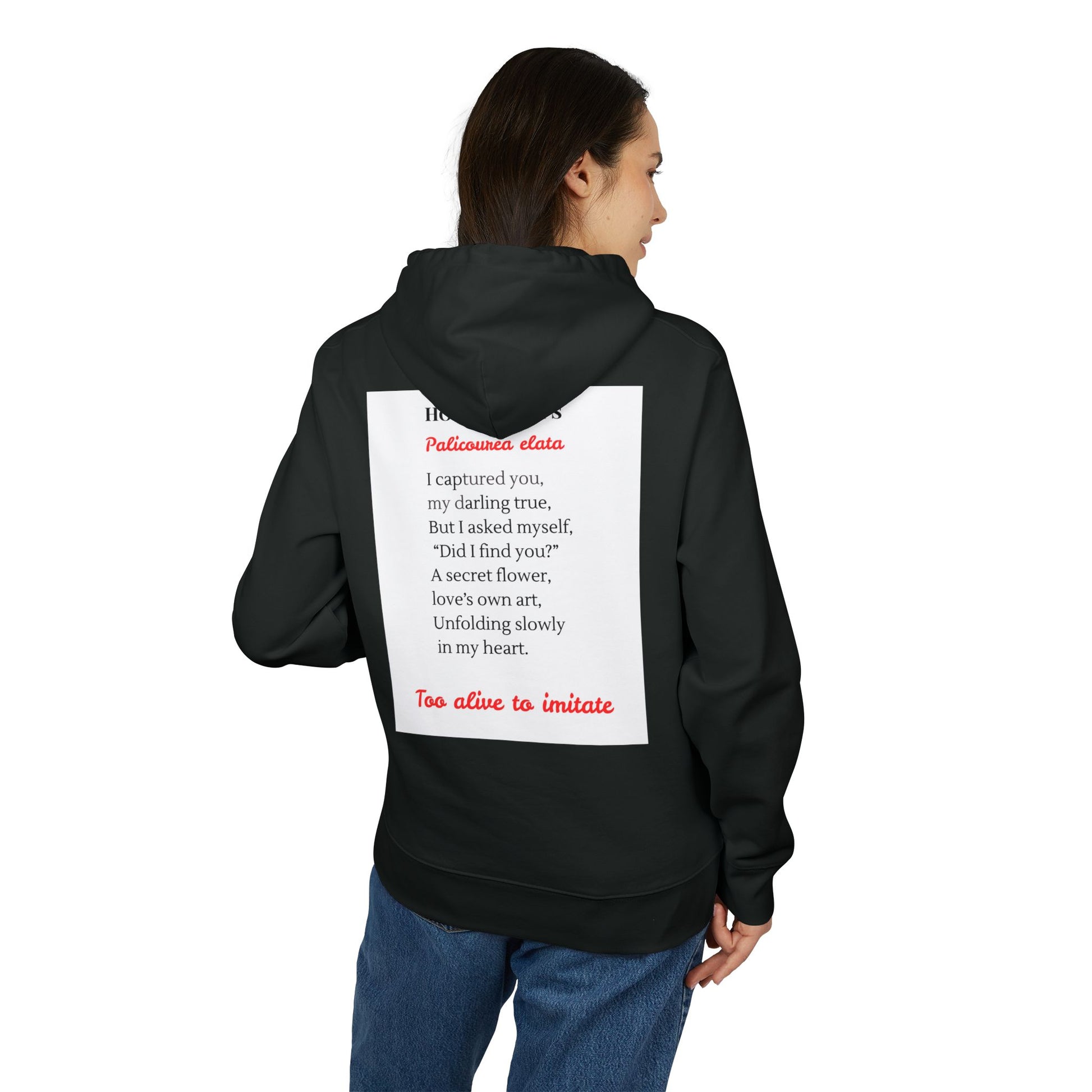Person wearing a black hoodie with text on the back against a white background