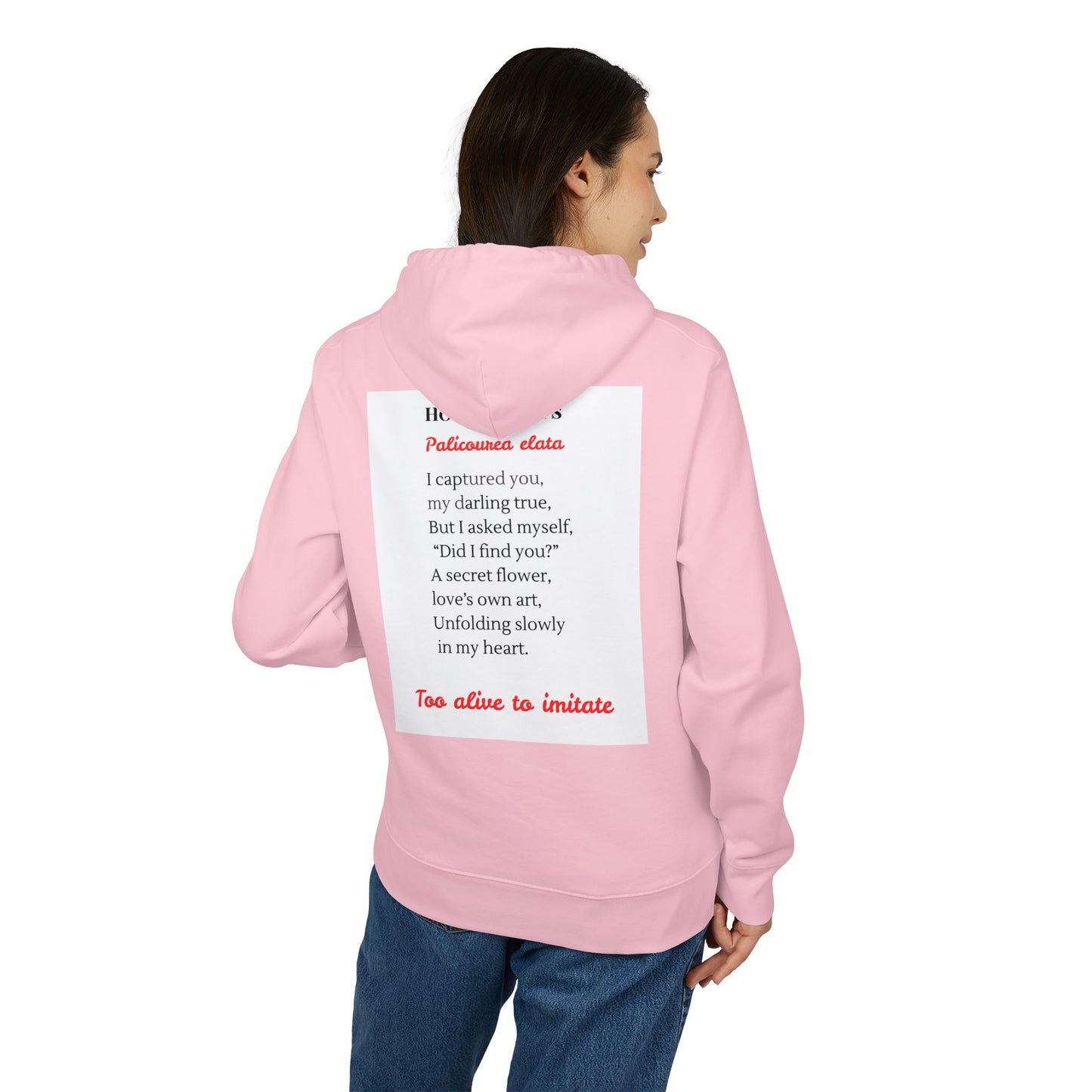 Person wearing a pink hoodie with text on the back against a white background
